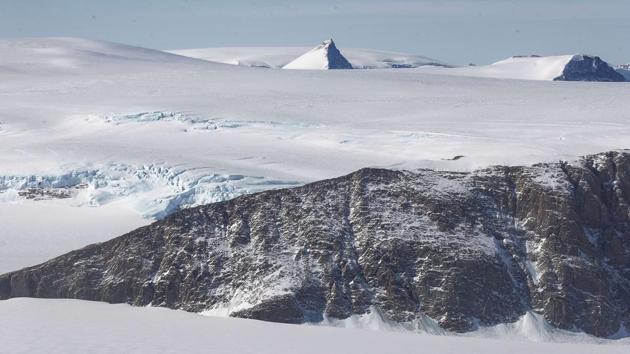 A nunatak (C), or mountain peak, is seen projecting through ice, near the coast of the Antarctic Peninsula region. According to NASA, the current mission targets ‘sea ice in the Bellingshausen and Weddell seas and glaciers in the Antarctic Peninsula and along the English and Bryan Coasts.’ (Mario Tama / Getty Images / AFP)