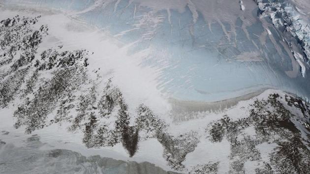 Blue ice (Top R) along a ridge is seen in the Antarctic Peninsula region. Operation IceBridge is the largest airborne survey of Earth’s polar ice ever flown. It will yield an unprecedented three-dimensional view of Arctic and Antarctic ice sheets, ice shelves and sea ice. (Mario Tama / Getty Images / AFP)