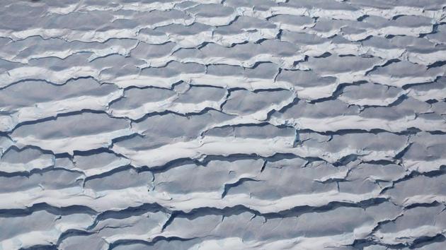Crevasses in ice seen from a research aircraft, above Antarctica. Operation IceBridge began in 2009 and is currently planned to continue until 2020 so it to overlaps with the Ice, Clouds, and Land Elevation Satellite (ICESat)-2 mission to help scientists connect measurements from the two satellites. (Mario Tama / Getty Images / AFP)