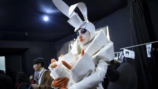 A model in an outfit presumably inspired by the White Rabbit from Lewis Carroll’s Alice in Wonderland, stands backstage before the Hu Sheguang collection showcase during China Fashion Week in Beijing on November 7, 2017. (Wang Zhao / AFP) A model in an outfit presumably inspired by the White Rabbit from Lewis Carroll’s Alice in Wonderland, stands backstage before the Hu Sheguang collection showcase during China Fashion Week in Beijing on November 7, 2017. (Wang Zhao / AFP)