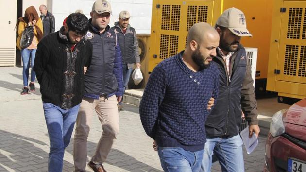 Turkish police officers escort people suspected of being Islamic group militants, outside a court in the Black sea region city of Samsun, Turkey, Thursday, Nov. 9, 2017. (AP) Turkish police officers escort people suspected of being Islamic group militants, outside a court in the Black sea region city of Samsun, Turkey, Thursday, Nov. 9, 2017. (AP)