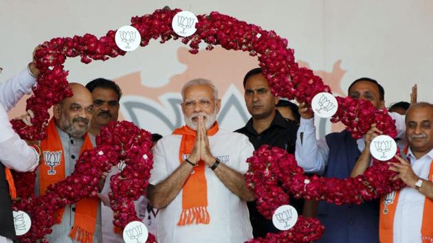 Prime Minister Narendra Modi and BJP president Amit Shah being garlanded during “Gujarat Gaurav Mahasammelan” in Ahmedabad. (PTI Photo) Prime Minister Narendra Modi and BJP president Amit Shah being garlanded during “Gujarat Gaurav Mahasammelan” in Ahmedabad. (PTI Photo)