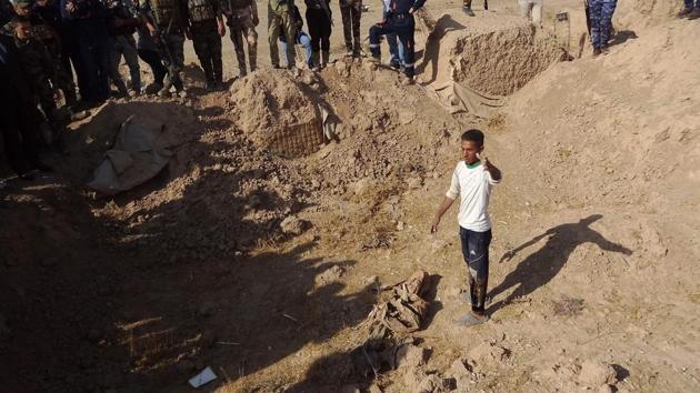 Iraqi forces search the site of a suspected mass grave containing the remains of victims of the Islamic State group, near the former al bakara military base, south west of Hawija on November 11. (AFP Photo) Iraqi forces search the site of a suspected mass grave containing the remains of victims of the Islamic State group, near the former al bakara military base, south west of Hawija on November 11. (AFP Photo)