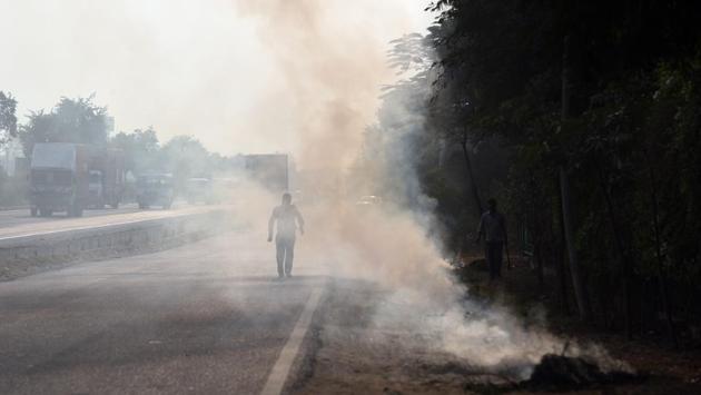 Apart from stubble burning and pollution from vehicular traffic, waste and dry leaves have also heightened the smog crisis in Delhi- NCR. One such scene can be seen here on the NH-8 at the Dharuhera border in New Delhi. (Ravi Choudhary / HT Photo) Apart from stubble burning and pollution from vehicular traffic, waste and dry leaves have also heightened the smog crisis in Delhi- NCR. One such scene can be seen here on the NH-8 at the Dharuhera border in New Delhi. (Ravi Choudhary / HT Photo)