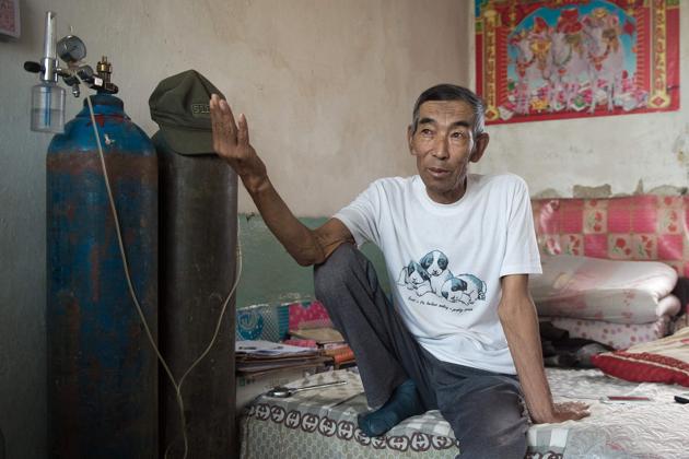 Farmer Wang Enlin sits in his room inside his house in Yushutun. (AFP Photo) Farmer Wang Enlin sits in his room inside his house in Yushutun. (AFP Photo)