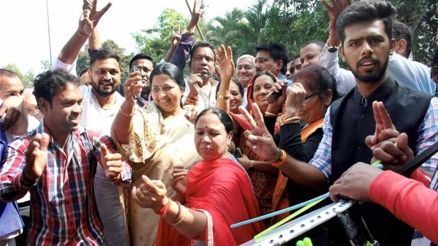 Madhya Pradesh Congress party workers celebrate the party's victory in Chitrakoot bypoll at party headquarters in Bhopal on Sunday.(PTI Photo)