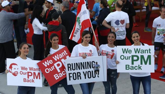 Lebanese women hold placards supporting the outgoing Lebanese Prime Minister Saad Hariri to return from Saudi Arabia during the Beirut Marathon in Beirut, Lebanon, Sunday. (AP Photo) Lebanese women hold placards supporting the outgoing Lebanese Prime Minister Saad Hariri to return from Saudi Arabia during the Beirut Marathon in Beirut, Lebanon, Sunday. (AP Photo)