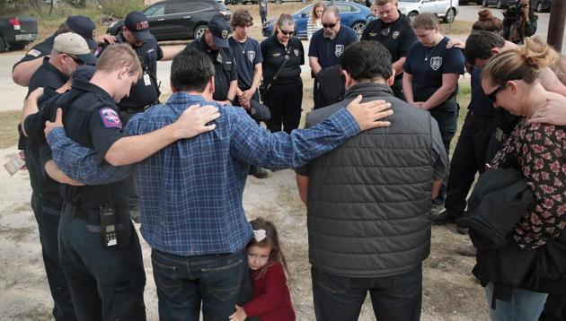 First responders share a prayer following a Veterans Day ceremony outside the Community Center on November 11, 2017 in Sutherland Springs, Texas. The men and women were among the first to enter the First Baptist Church of Sutherland Springs to begin treating the wounded following the shooting on November 5. (AFP) First responders share a prayer following a Veterans Day ceremony outside the Community Center on November 11, 2017 in Sutherland Springs, Texas. The men and women were among the first to enter the First Baptist Church of Sutherland Springs to begin treating the wounded following the shooting on November 5. (AFP)