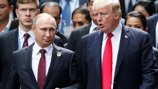 US President Donald Trump and Russia's President Vladimir Putin talk as they make their way to take the "family photo" during the APEC leaders' summit in the central Vietnamese city of Danang on November 11, 2017. (AFP) US President Donald Trump and Russia's President Vladimir Putin talk as they make their way to take the "family photo" during the APEC leaders' summit in the central Vietnamese city of Danang on November 11, 2017. (AFP)