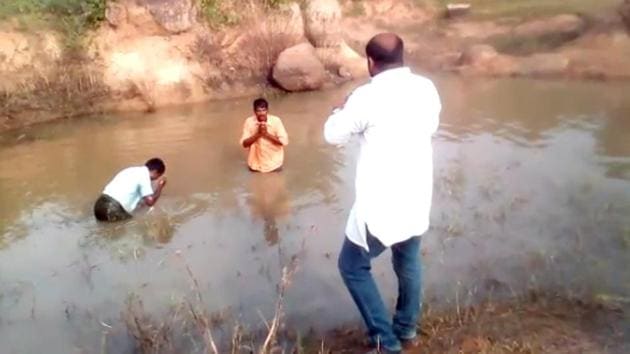 In the video, Reddy forces them to enter a muddy pool on the roadside and drink from it.(Screenshot from video) In the video, Reddy forces them to enter a muddy pool on the roadside and drink from it.(Screenshot from video)