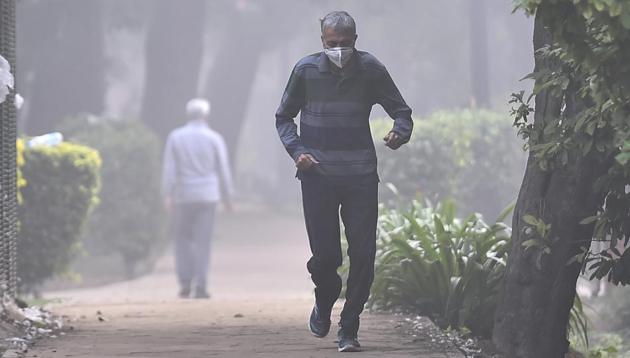 A man, wearing an anti-pollution mask, jogs through smog at Sanjay Park in New Delhi on Monday. (PTI) A man, wearing an anti-pollution mask, jogs through smog at Sanjay Park in New Delhi on Monday. (PTI)