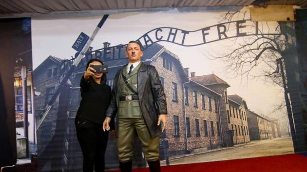An Indonesian woman takes a selfie with a life-size wax sculpture of Adolf Hitler at a museum in Yogyakarta. The exhibit has now been removed following international outrage.(AFP)
