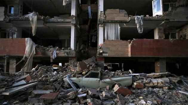 A car lays smashed by debris from the earthquake at the city of Sarpol-e-Zahab in western Iran, on November 13, 2017. The head of Iranian Red Crescent said more than 70,000 people were in need of emergency shelter. The Iranian armed forces have been deployed to help the emergency services. (Pouria Pakizeh / ISNA via AP) A car lays smashed by debris from the earthquake at the city of Sarpol-e-Zahab in western Iran, on November 13, 2017. The head of Iranian Red Crescent said more than 70,000 people were in need of emergency shelter. The Iranian armed forces have been deployed to help the emergency services. (Pouria Pakizeh / ISNA via AP)