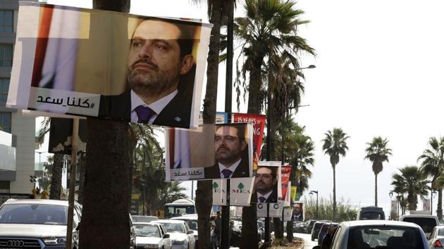 Posters of Lebanese Prime Minister Saad Hariri, who resigned last week in a televised speech airing from the Saudi capital Riyadh, hang on Beirut's seaside corniche on November 10, 2017, with a caption reading below in Arabic: "#We_are_all_Saad". (AFP) Posters of Lebanese Prime Minister Saad Hariri, who resigned last week in a televised speech airing from the Saudi capital Riyadh, hang on Beirut's seaside corniche on November 10, 2017, with a caption reading below in Arabic: "#We_are_all_Saad". (AFP)