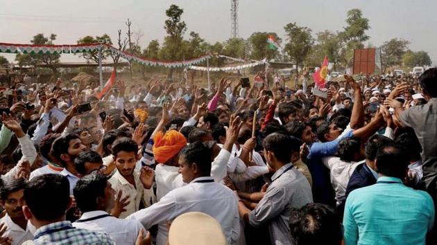 People throng the streets during an election campaign road show in Banaskantha district of Gujarat.(PTI Photo)
