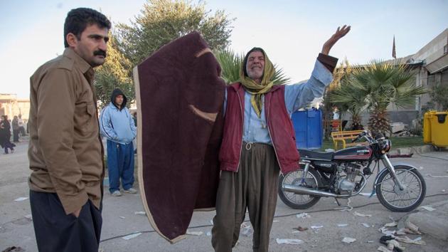 A man reacts following an earthquake in Sarpol-e Zahab county in Kermanshah, Iran.(Tasnim News Agency via Reuters Photo)