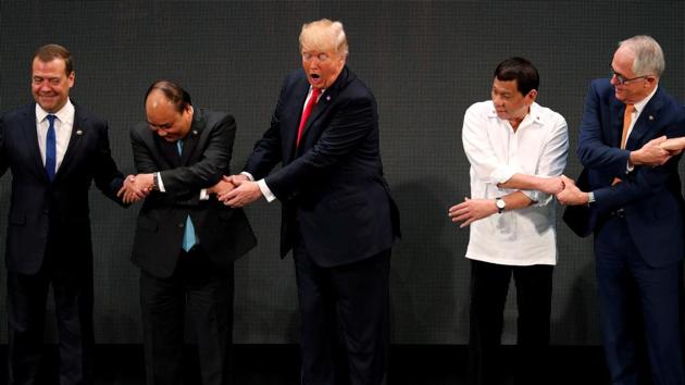 US President Donald Trump registers his surprise as he realizes other leaders, including Russia's Prime Minister Dmitry Medvedev, Vietnam's Prime Minister Nguyen Xuan Phuc, President of the Philippines Rodrigo Duterte and Australia's Prime Minister Malcolm Turnbull, are crossing their arms for the traditional “ASEAN handshake” as he participates in the opening ceremony of the ASEAN Summit in Manila on Monday. (REUTERS) US President Donald Trump registers his surprise as he realizes other leaders, including Russia's Prime Minister Dmitry Medvedev, Vietnam's Prime Minister Nguyen Xuan Phuc, President of the Philippines Rodrigo Duterte and Australia's Prime Minister Malcolm Turnbull, are crossing their arms for the traditional “ASEAN handshake” as he participates in the opening ceremony of the ASEAN Summit in Manila on Monday. (REUTERS)
