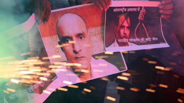 People hold posters of Indian naval officer Kulbhushan Jadhav as they celebrate the International Court of Justice staying the execution of Jadhav, in Ahmadabad, in May 2017.(Siddharaj Solanki/ HT File Photo)