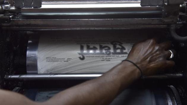 Umesh, a worker prepares the offset machine for printing the two page daily newspaper Sudharma at its press. The manpower in the operation is minimal, the infrastructure skeletal. (Arijit Sen / HT Photo)