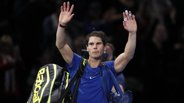 Rafael Nadal waves to supporters after losing his ATP Finals match against David Goffin in London.(AP)
