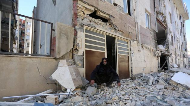 A man sits outside a damaged following a devastating 7.3-magnitude earthquake in Sarpol-e Zahab county in Kermanshah, Iran.(REUTERS) A man sits outside a damaged following a devastating 7.3-magnitude earthquake in Sarpol-e Zahab county in Kermanshah, Iran.(REUTERS)