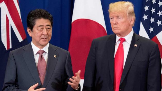 Japan's Prime Minister Shinzo Abe (L) talks to US President Donald Trump during the opening ceremony of the Summit in Manila. (Jim Watson / AFP)
