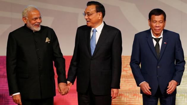 Prime Minister Narendra Modi (L) and Chinese Premier Li Keqiang hold hands as Philippine President Rodrigo Duterte prepares to walk to chair his meeting of the East Asia Summit or EAS at the ongoing 31st ASEAN Summit on November 14 in Manila, Philippines. (REUTERS) Prime Minister Narendra Modi (L) and Chinese Premier Li Keqiang hold hands as Philippine President Rodrigo Duterte prepares to walk to chair his meeting of the East Asia Summit or EAS at the ongoing 31st ASEAN Summit on November 14 in Manila, Philippines. (REUTERS)