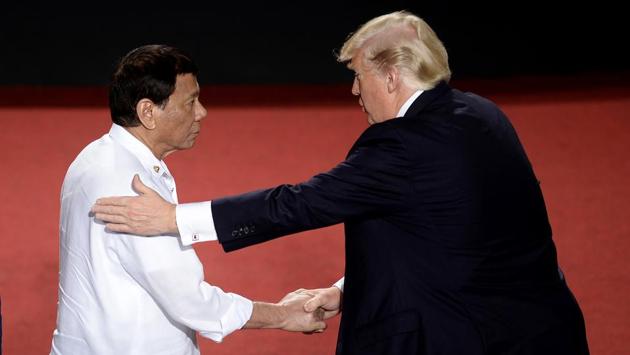 Philippine President Rodrigo Duterte (L), shakes hands with U.S. President Donald Trump during the ASEAN Summit on Monday. Their meeting was one of the most anticipated of the summit, with human rights groups pressing Trump to take a tough line on Duterte over his bloody war on drugs, in which thousands of people have been killed. (Noel Celis / AP)