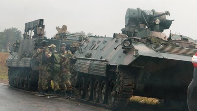 Soldiers stand beside military vehicles just outside Harare, Zimbabwe, on November 14,2017. (Reuters) Soldiers stand beside military vehicles just outside Harare, Zimbabwe, on November 14,2017. (Reuters)