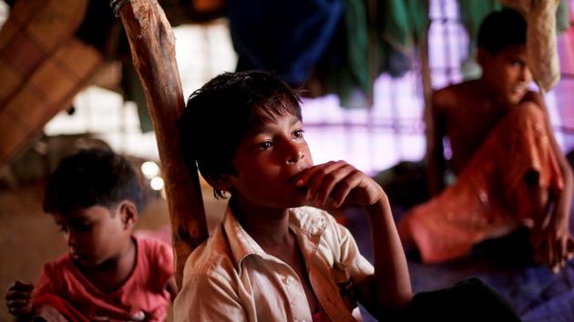 A pensive Nur listens to his mother in their shelter. With his family huddled under a tarpaulin tent and his mother needing help to feed his siblings, the youngest two of whom suffer malnourishment, a normal child’s life is not in his immediate future. (Adnan Abidi / REUTERS) A pensive Nur listens to his mother in their shelter. With his family huddled under a tarpaulin tent and his mother needing help to feed his siblings, the youngest two of whom suffer malnourishment, a normal child’s life is not in his immediate future. (Adnan Abidi / REUTERS)