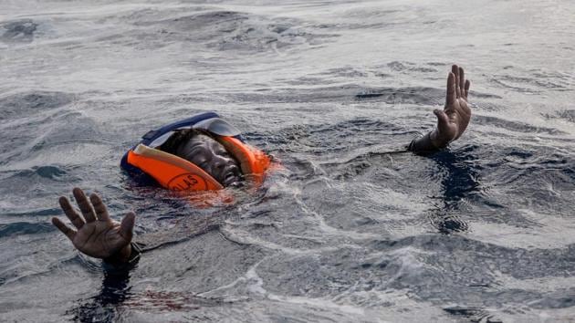 A migrant tries to board a boat of the German NGO Sea-Watch in the Mediterranean Sea on November 6, 2017. (AFP Photo/Alessio Paduano) A migrant tries to board a boat of the German NGO Sea-Watch in the Mediterranean Sea on November 6, 2017. (AFP Photo/Alessio Paduano)