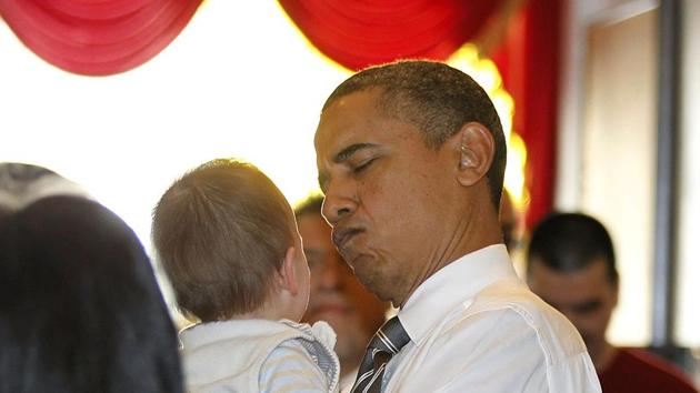 Barack Obama reacts while holding a baby as he greets diners at the Great Eastern Chinese restaurant in San Francisco. (Reuters File Photo)