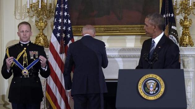 Former vice-president Joe Biden turns away as he wipes away tears after Barack Obama surprised him during a ceremony in the State Dining Room of the White House in Washington, to present him with the Presidential Medal of Freedom. (AP File Photo)