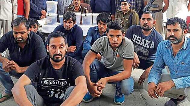 The accused in police custody on Tuesday. Police had announced a reward of Rs 7 lakh on one of the men arrested.(HT Photo)