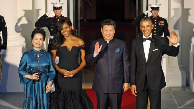 Ex-president Barack Obama and Chinese President Xi Jinping wave along with their wives Peng Liyuan and former US first lady Michelle Obama as they arrive for a state dinner at the White House. (AP File Photo)