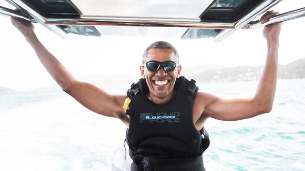 Former US President Barack Obama sits on a boat during a kite surfing outing with British businessman Richard Branson during his holiday on Branson's Moskito island, in the British Virgin Islands. (REUTERS file photo)
