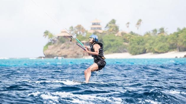 Former US president Barack Obama tries his hand at kite surfing during a holiday with British businessman Richard Branson on his island Moskito. (Virgin Handout via REUTERS)