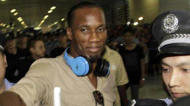 Former Chelsea star Didier Drogba is escorted by police officers upon his arrival at Pudong International Airport in Shanghai in June 2012. Drogba signed with Chinese soccer club Shanghai Shenhua on a two-year contract that reportedly made him China's highest-paid player. (AP) Former Chelsea star Didier Drogba is escorted by police officers upon his arrival at Pudong International Airport in Shanghai in June 2012. Drogba signed with Chinese soccer club Shanghai Shenhua on a two-year contract that reportedly made him China's highest-paid player. (AP)