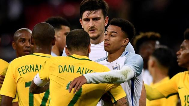 England’s Jesse Lingard, Harry Maguire and Brazil’s Dani Alves interact after their international friendly encounter. (REUTERS) England’s Jesse Lingard, Harry Maguire and Brazil’s Dani Alves interact after their international friendly encounter. (REUTERS)