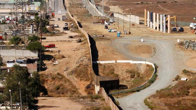 Prototypes (right) for US President Donald Trump's border wall with Mexico are shown near completion in this picture taken from the Mexican side of the border, in Tijuana, Mexico. (Reuters File Photo) Prototypes (right) for US President Donald Trump's border wall with Mexico are shown near completion in this picture taken from the Mexican side of the border, in Tijuana, Mexico. (Reuters File Photo)