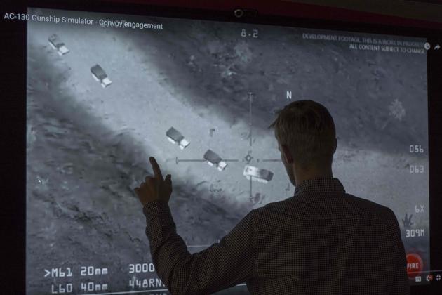 In this November 14, 2017, photo illustration a journalist in Washington, DC, looks at YouTube video showing images from an aerial assault video game. Russia's defence ministry on Tuesday shared the same footage on its own channels, saying it proved the US was aiding the Islamic State in the Middle East. (AFP Photo) In this November 14, 2017, photo illustration a journalist in Washington, DC, looks at YouTube video showing images from an aerial assault video game. Russia's defence ministry on Tuesday shared the same footage on its own channels, saying it proved the US was aiding the Islamic State in the Middle East. (AFP Photo)