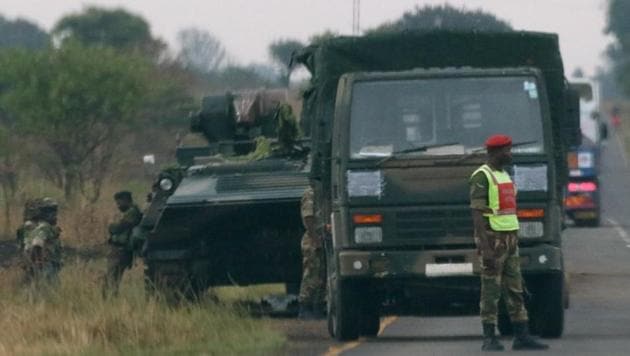 Soldiers stand beside military vehicles just outside Harare, Zimbabwe.(Reuters Photo)