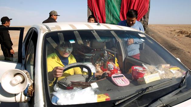 A woman stops to sell food to truck drivers near the border with China. A megaphone mounted on her car plays a recording letting drivers know she can offer food, water and fresh meat. Alongside the trucks a bustling micro economy has sprung up of traders peddling cigarettes, water and diesel as drivers wait to clear Chinese customs in a queue that can stretch for 130 kilometres. (B. Rentsendorj / Reuters)