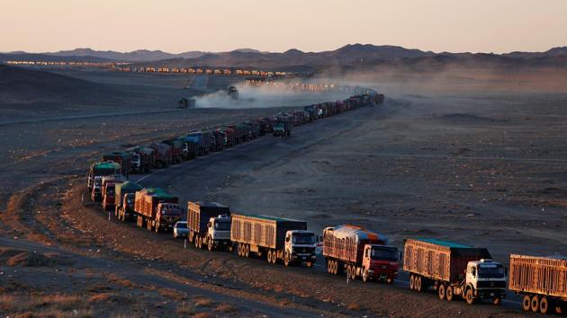 Thousands of heavy-duty trucks loaded with coal line up along the Mongolia-China border in the Gobi desert. A rebound in coal prices and a surge in exports to China this year have meant a bonanza for miners in Mongolia but long delays along the export route threaten this burgeoning lifeline in an ailing economy. (B. Rentsendorj / Reuters)