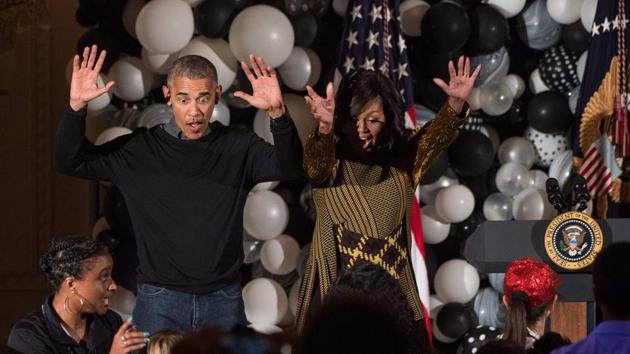 Barack and Michelle Obama dance along with children performing Michael Jackson Thriller in the East Room at the White House during a Halloween event in Washington, DC. (AFP File Photo)