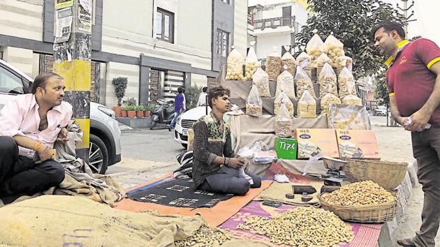 Mustafa sells chikki, revri and gajak at his roadside stall in north Delhi’s Rithala.(Mayank Austen Soofi / HT PHOTO)