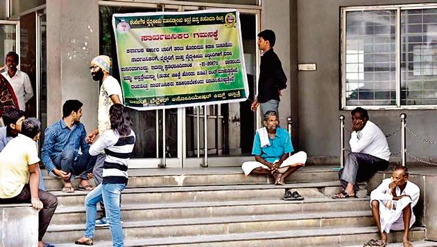 People sit outside the closed Out-Patient Department (OPD) of KIMS hospital in Bengaluru.(Arijit Sen) People sit outside the closed Out-Patient Department (OPD) of KIMS hospital in Bengaluru.(Arijit Sen)
