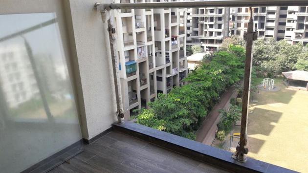 The balcony from where the two-year-old child fell to her death. The glass railings were removed after a railing fell from one of the top floors of the building a few days earlier. (HT PHOTO) The balcony from where the two-year-old child fell to her death. The glass railings were removed after a railing fell from one of the top floors of the building a few days earlier. (HT PHOTO)