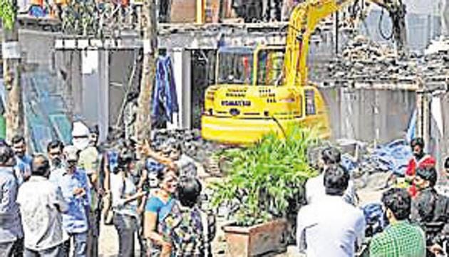 The K-West ward office razed four of 10 big commercial structures, including a showroom and a bar, on a part of this road on Wednesday. (SHASHI KASHYAP) The K-West ward office razed four of 10 big commercial structures, including a showroom and a bar, on a part of this road on Wednesday. (SHASHI KASHYAP)