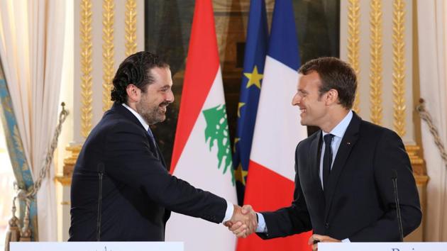 (FILES) This file photo taken on September 1, 2017 shows French President Emmanuel Macron (R) shaking hands with Lebanese Prime Minister Saad Hariri during a press conference at the Murat Lounge in the Elysee Palace in Paris. (AFP) (FILES) This file photo taken on September 1, 2017 shows French President Emmanuel Macron (R) shaking hands with Lebanese Prime Minister Saad Hariri during a press conference at the Murat Lounge in the Elysee Palace in Paris. (AFP)